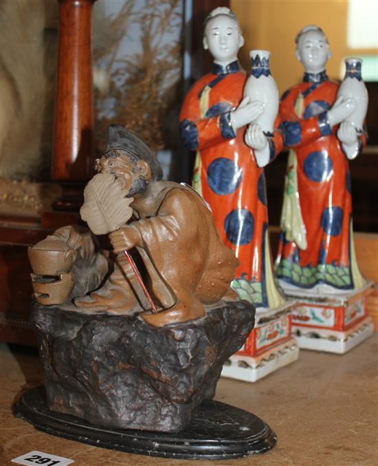 Pair Chinese porcelain figures and a similar stoneware group